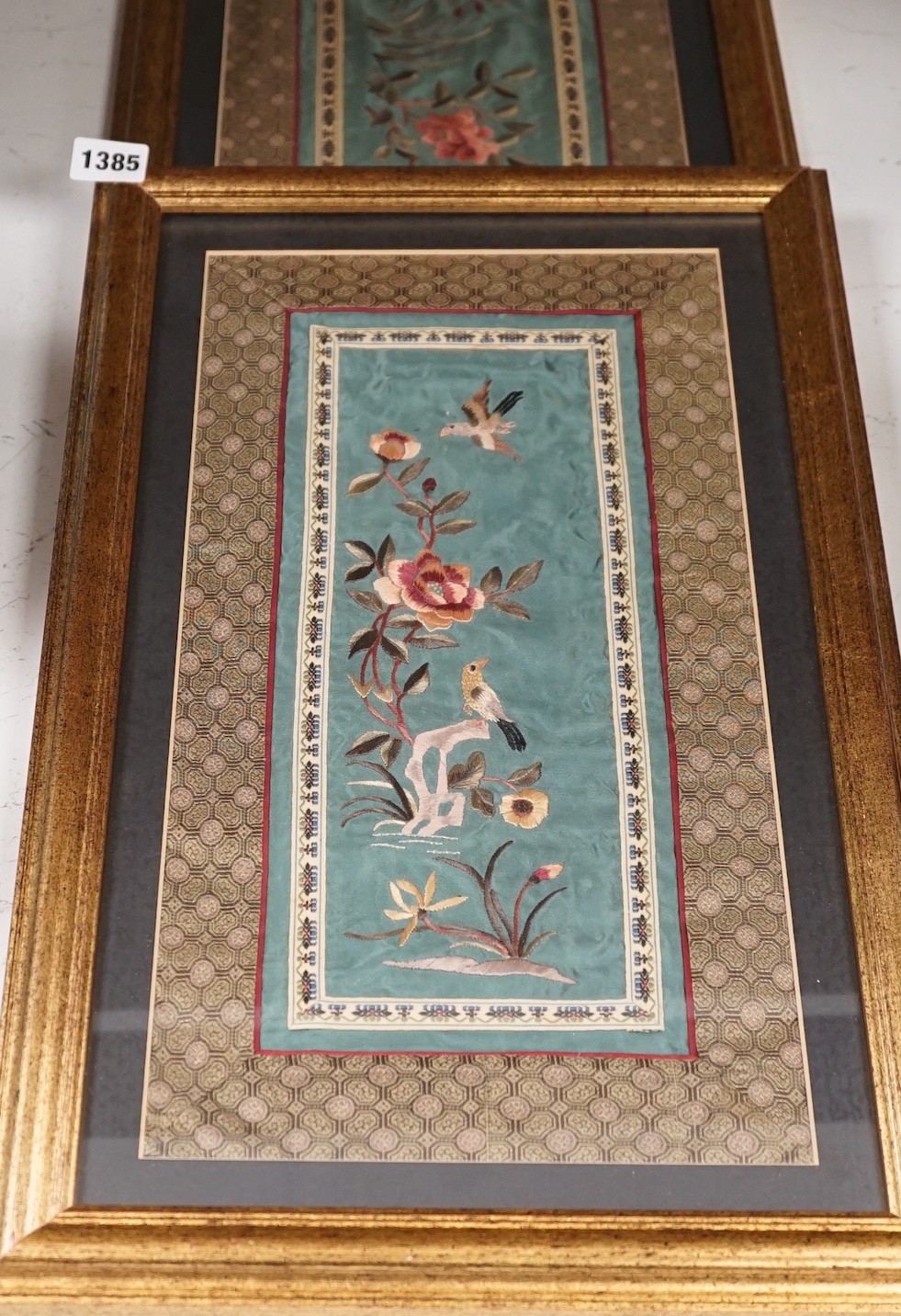 A pair of framed Chinese embroideries with bird and flower decoration, 34 x 14cm